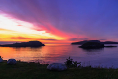 Vibrant sunset over the ocean islands near Witless Bay Ecological Reserve Newfoundland.